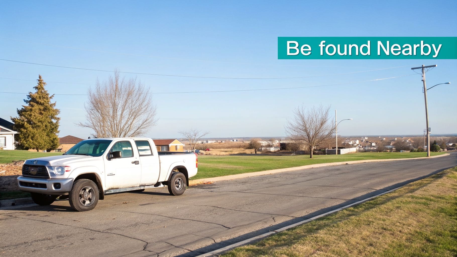 A white pickup truck parked on a street in a suburban setting with a teal 'Be found Nearby' banner.