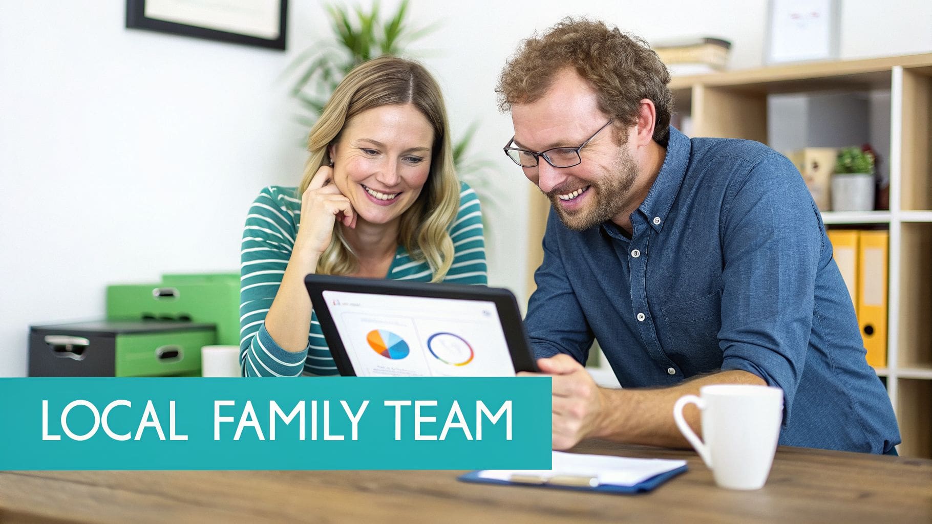 Smiling man and woman looking at a tablet with charts, text 'LOCAL FAMILY TEAM' in foreground.
